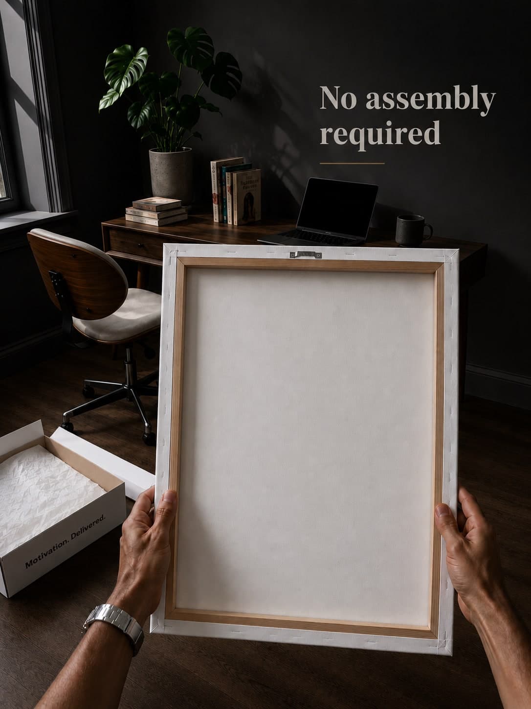 Hands holding the back of an assembled framed canvas